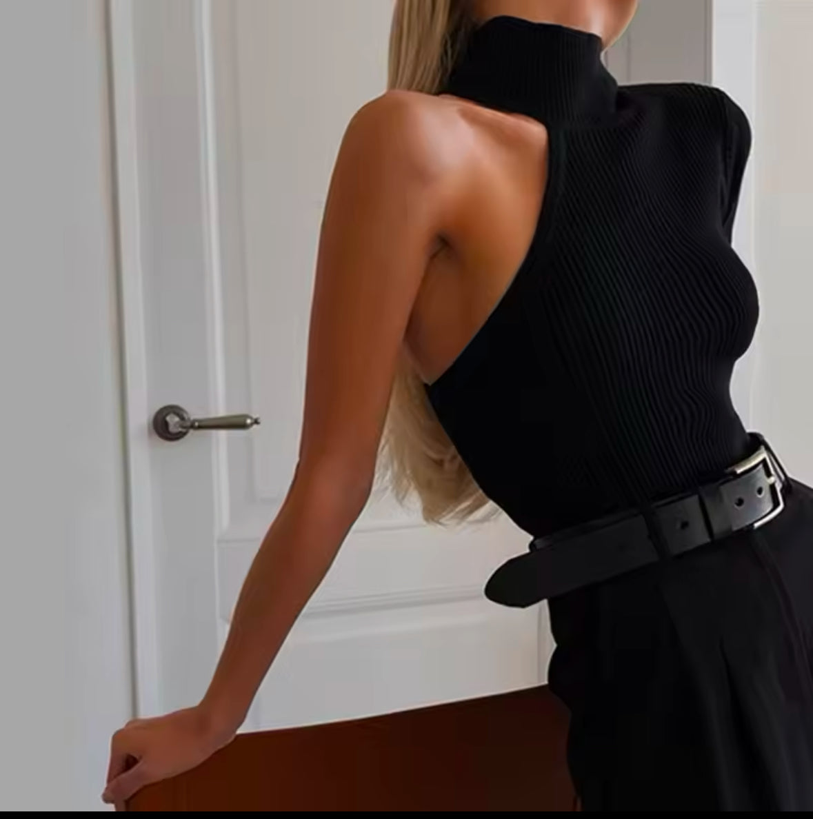 Schwarzes, asymmetrisches One-Shoulder Strick-Top mit hohem Kragen. Figurbetonte Passform, ideal für elegante und moderne Looks.