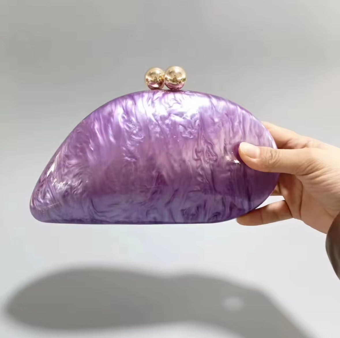 Fliederfarbene Clutch mit Marmorstruktur